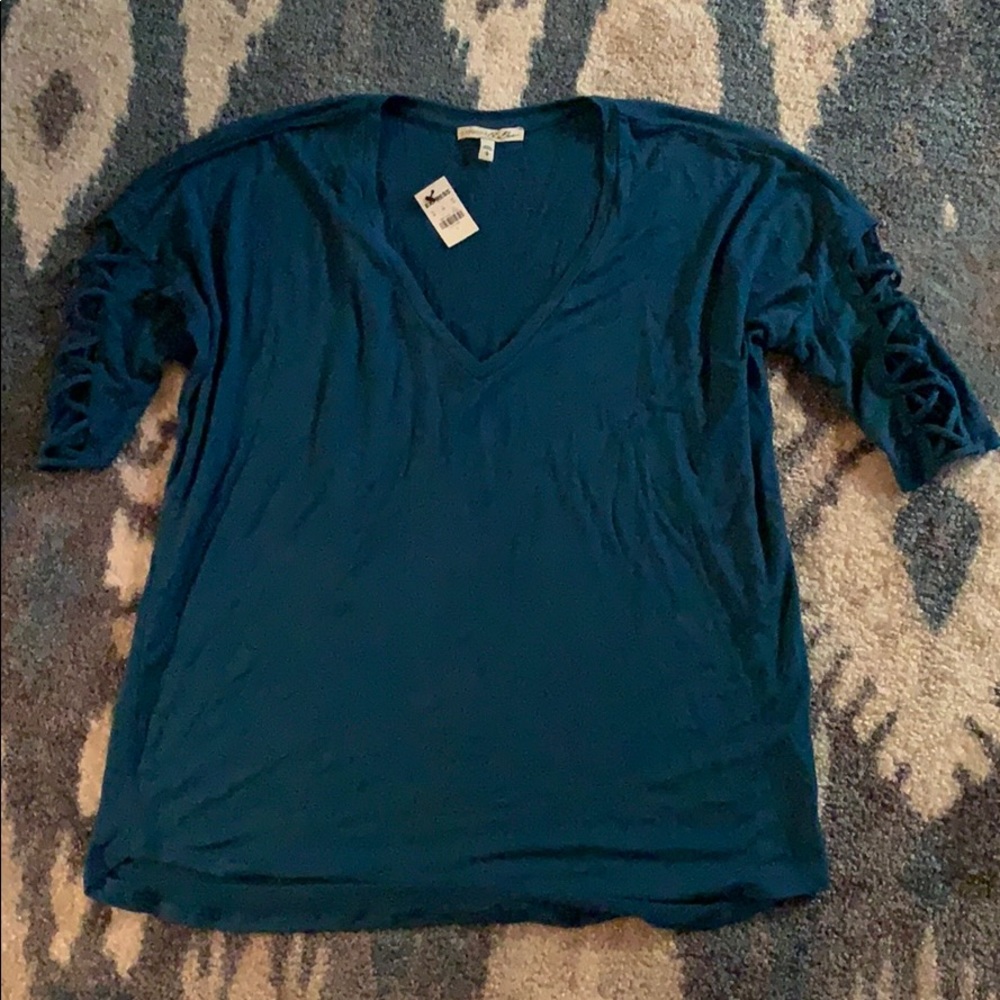 NWT Express tee with cross cross detailing on arms
